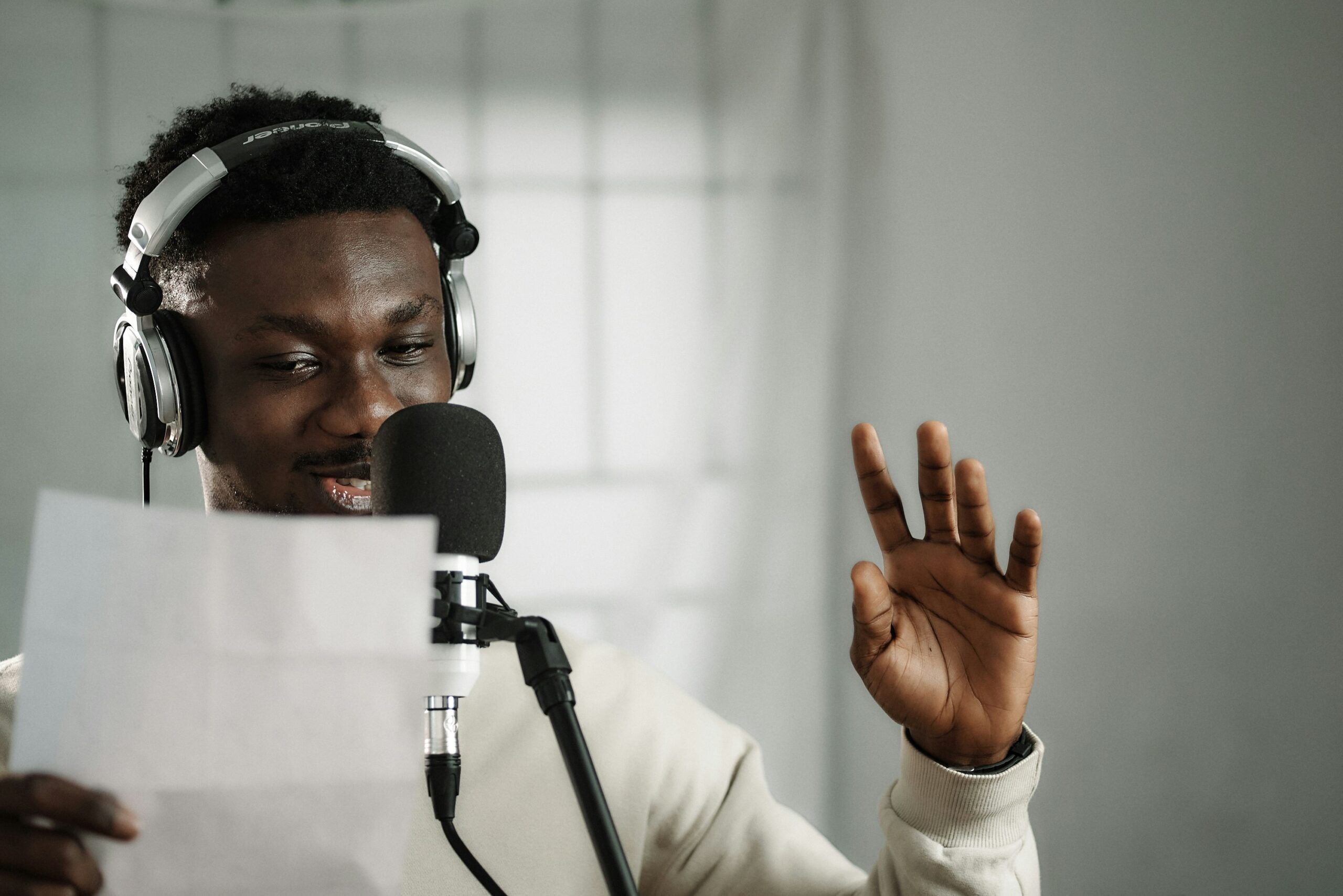 a voice actor reading a script into a microphone