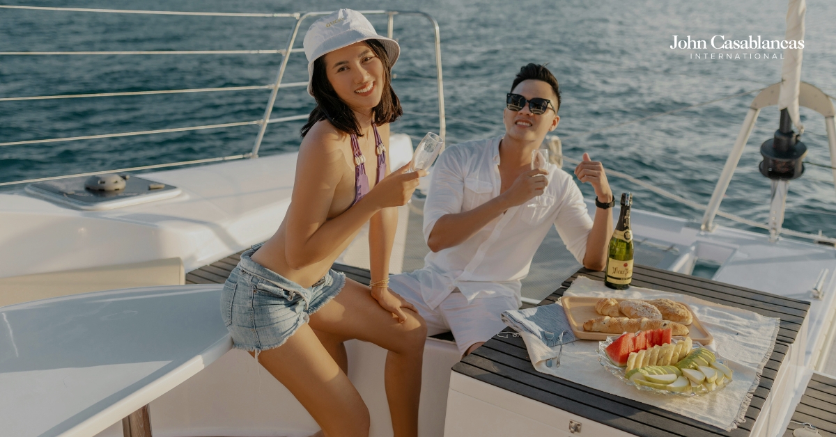 two models striking a pose on a boat on the water