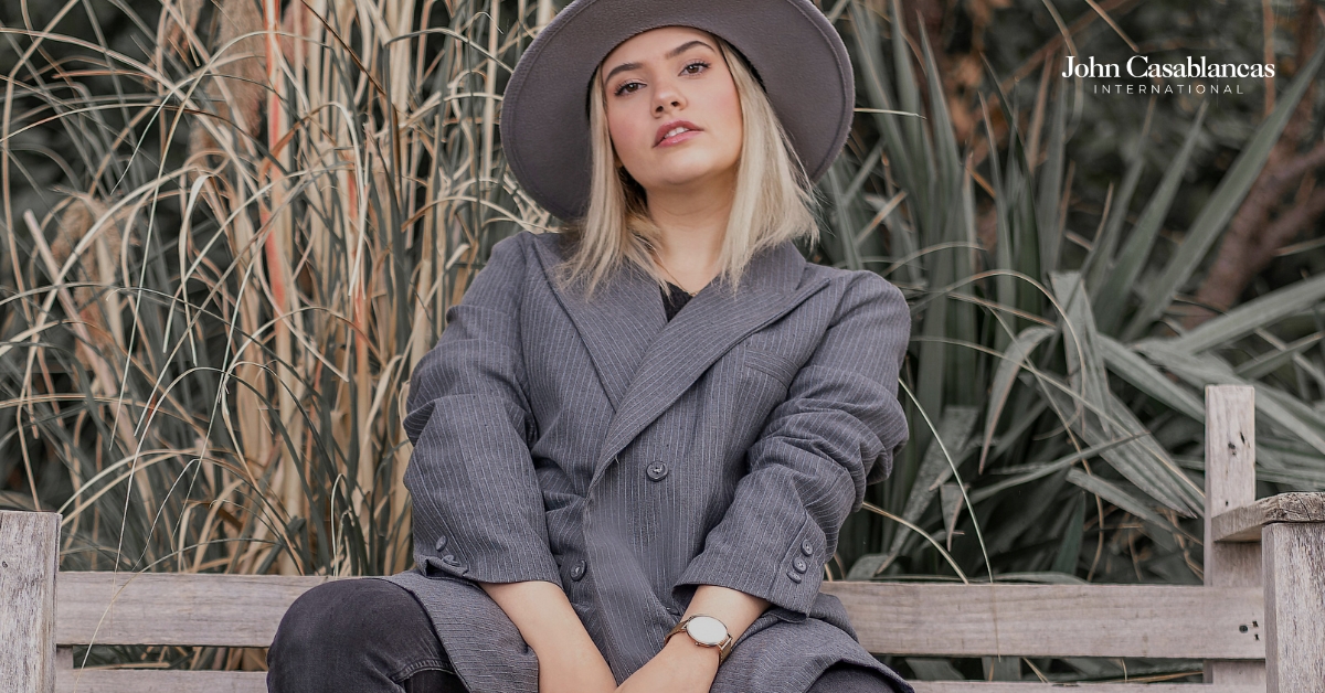 blonde model posing in a gray outfit