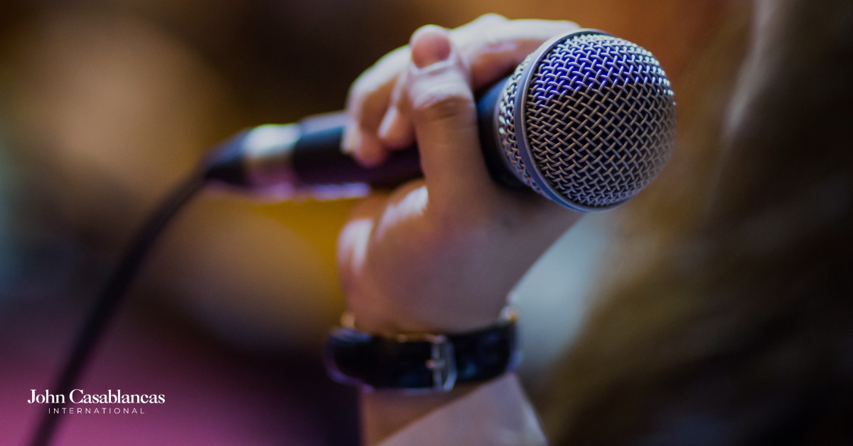 a hand holding a microphone
